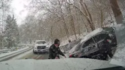 Two Collier Township, PA, EMS workers at an accident scene scramble out of the way of a pickup truck after it lost control and slammed into an emergency vehicle Wednesday.