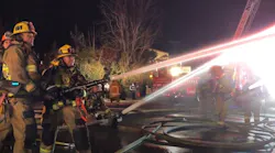 More than 100 Los Angeles City firefighters battled a fire that spread to two commercial buildings and collapsed the roof of one of the structures Monday.