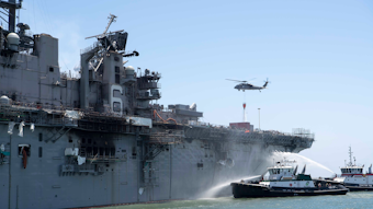 Fire boats douse the USS Richard Bonhomme, which caught fire while docked in San Diego in July.