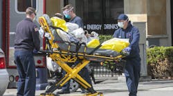 Firefighters and paramedics attend to a patient in downtown San Diego wearing face, hand and eye protective gear on April 8. Firefighters and paramedics attend to a patient in downtown San Diego wearing face, hand and eye protective gear on April 8.