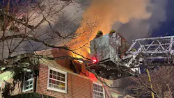 Around 60 Montgomery County, MD, firefighters battled a massive fire that broke out at an unoccupied house in Silver Spring early Tuesday.
