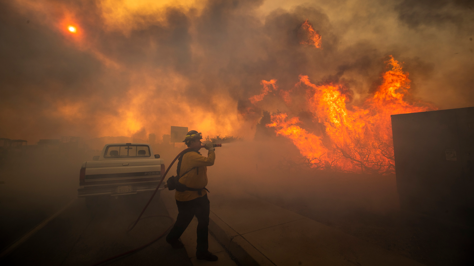 Firefighter Raymond Vasquez braves tall flames as he fights the advancing Silverado Fire, fueled by Santa Ana winds, at the 241 toll road and Portola Parkway in Irvine, CA, on Oct. 26.