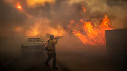 Firefighter Raymond Vasquez braves tall flames as he fights the advancing Silverado Fire, fueled by Santa Ana winds, at the 241 toll road and Portola Parkway in Irvine, CA, on Oct. 26.