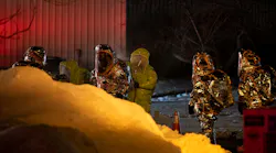 Hazmat crews work to clean up a nitric acid spill that occurred from a truck at Rafferty Aluminum & Steel in Sterling, MA, on Tuesday.