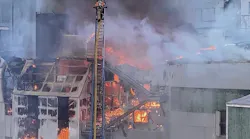 Clackamas, OR, Fire District #1 firefighters used aerials to battle a fire the tore through the closed Blue Heron paper mill in Oregon City on Saturday.