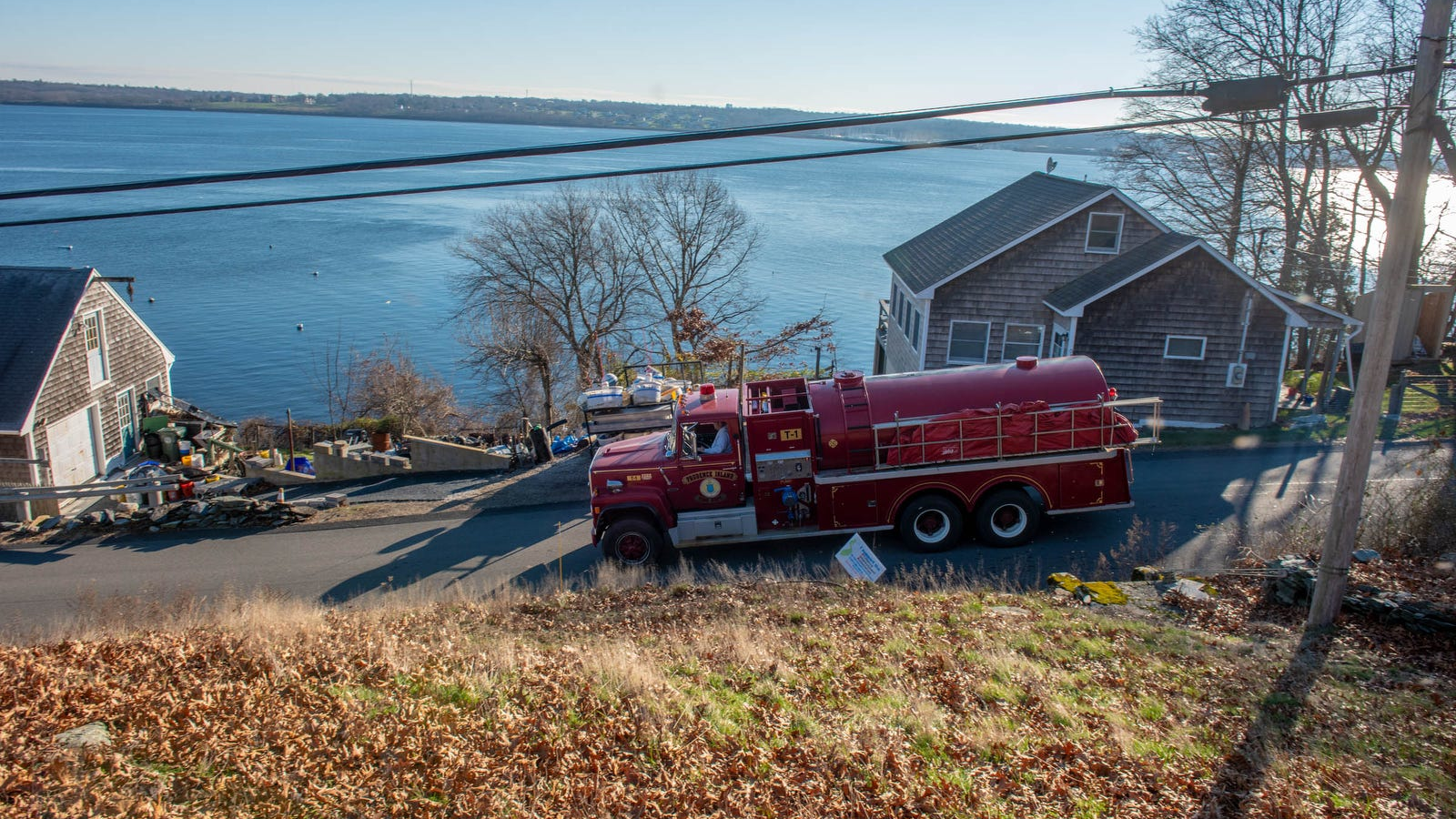 As many as 35 firefighters from multiple departments battled a propane-fueled fire that destroyed three Prudence Island, RI, homes late Thursday.