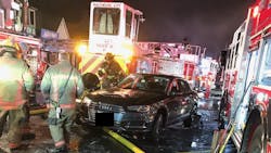Baltimore firefighters assess the damage after a vehicle drove through the scene of a three-alarm fire. Baltimore firefighters assess the damage after a vehicle drove through the scene of a three-alarm fire.