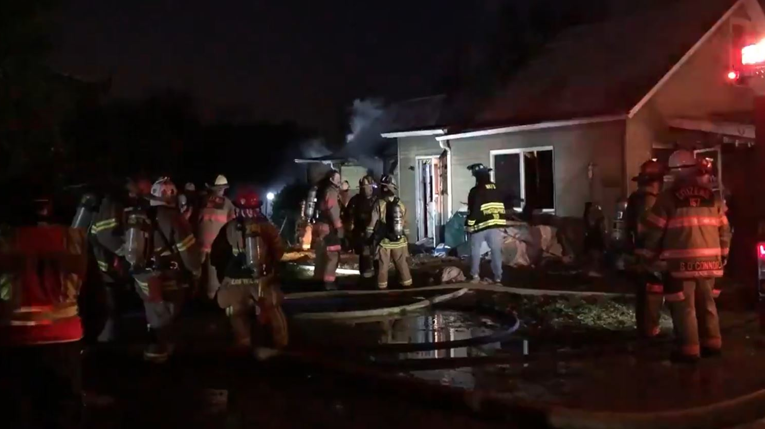 This screen capture from a Twitter video shows firefighters on the scene during a fire at a home in Harrison, PA, on Dec. 31, 2020.