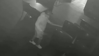 Asif Raja, 54, is seen on surveillance video pouring an accelerant on tables at a hookah lounge in Queens, NY, before setting several fires on Aug. 4, 2021.