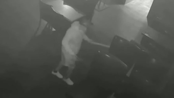 Asif Raja, 54, is seen on surveillance video pouring an accelerant on tables at a hookah lounge in Queens, NY, before setting several fires on Aug. 4, 2021.