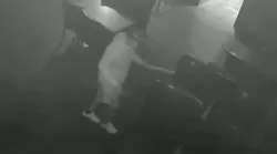 Asif Raja, 54, is seen on surveillance video pouring an accelerant on tables at a hookah lounge in Queens, NY, before setting several fires on Aug. 4, 2021.