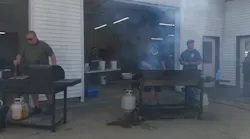 Firefighters man the grills during a drive-through pork chop fry to raise volunteer fire department funds in Chapin, IL, on Sept. 26. 2020.