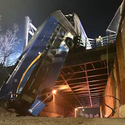 At least eight people were injured when a New York City tandem bus crashed through traffic barriers in the Bronx and fell 50 feet to the road below Thursday, leaving the vehicle dangling off an overpass.