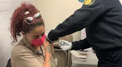 A member of the Philadelphia Fire Department is vaccinated for COVID-19. The department has begun vaccinating personnel, and by Tuesday, 100 members had received the shot.