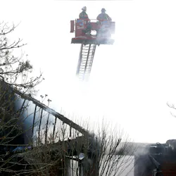 Smoke envelopes firefighters above a Manchester, NJ, duplex that was gutted by flames Friday.