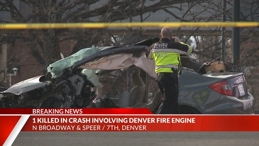 A mangled vehicle sits in the road after it was struck by a Denver Fire Department apparatus at an intersection on Saturday, Jan. 23, 2021.