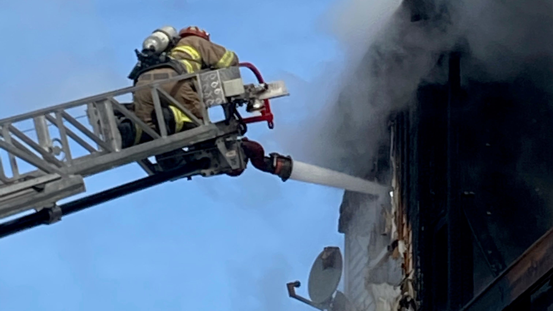 A Sutton, MA, firefighter suffered breathing problems and chest discomfort while battling a fire at a three-decker in Milbury on Sunday.