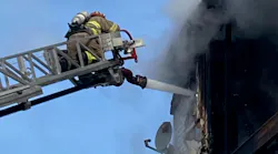 A Sutton, MA, firefighter suffered breathing problems and chest discomfort while battling a fire at a three-decker in Milbury on Sunday.