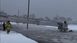 Stamford, CT, firefighters used an aerial to rescue two people from a sinking pickup truck Monday. Stamford, CT, firefighters used an aerial to rescue two people from a sinking pickup truck Monday.