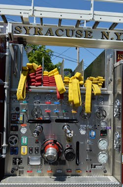 The Syracuse, NY, Fire Department uses a 60-inch-wide panel to accommodate four crosslay hosebeds along with the cradle for the TeleSqurt boom, with a standardized layout for all of the instruments, gauges and controls. Note the handrail locations and the use of an aggressive nonslip insert on the pump panel step.
