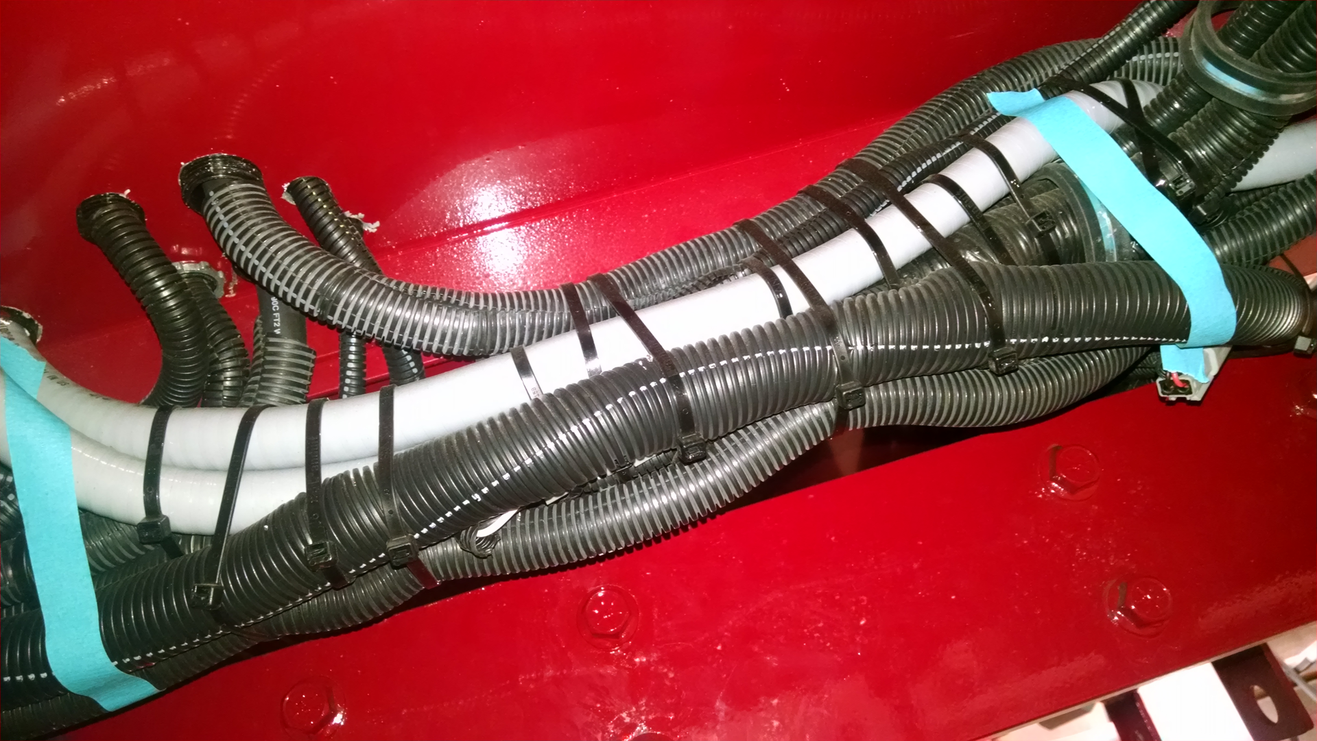Conducting virtual final inspections is difficult and requires cooperation between the department and the manufacturer to provide a large number of underchassis photos for review. Wire harnesses should be secured with stainless steel hard clamps, rather than reliance on multiple plastic wire ties.