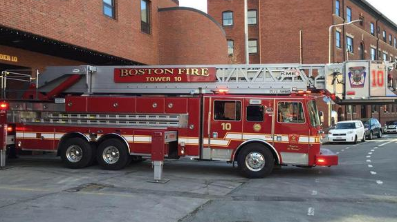 One person suffered minor injures after an SUV rear-ended a parked Boston Fire Department aerial early Monday.