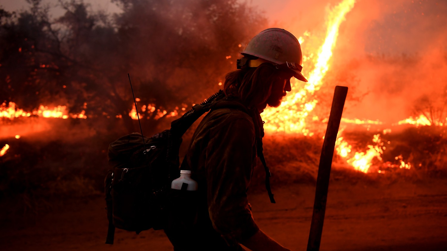 A firefighter helps to set back fires as the El Dorado Fire approaches Tucaipa, CA, in 2020.