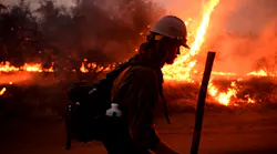 A firefighter helps to set back fires as the El Dorado Fire approaches Tucaipa, CA, in 2020.