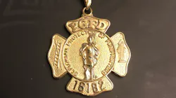 Prince George's County, MD, Battalion Chief Donny Fletcher lost his firefighter's necklace while on vacation in North Carolina last year, and it was discovered this year by a man with a metal detector. Prince George's County, MD, Battalion Chief Donny Fletcher lost his firefighter's necklace while on vacation in North Carolina last year, and it was discovered this year by a man with a metal detector.
