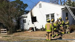 An off-duty firefighter and a civilian rushed into a burning house to save a person trapped inside Monday.