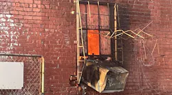 Oklahoma City, OK, firefighters needed to remove metal window bars to rescue a woman from a four-alarm fire moments before flames engulfed a commercial building Tuesday.