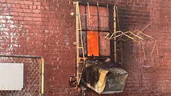 Oklahoma City, OK, firefighters needed to remove metal window bars to rescue a woman from a four-alarm fire moments before flames engulfed a commercial building Tuesday.