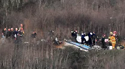 Officials remove a body from the wreckage of a helicopter crash that killed nine people, including NBA star Kobe Bryant, in Calabasas, CA, on Jan. 26, 2020.