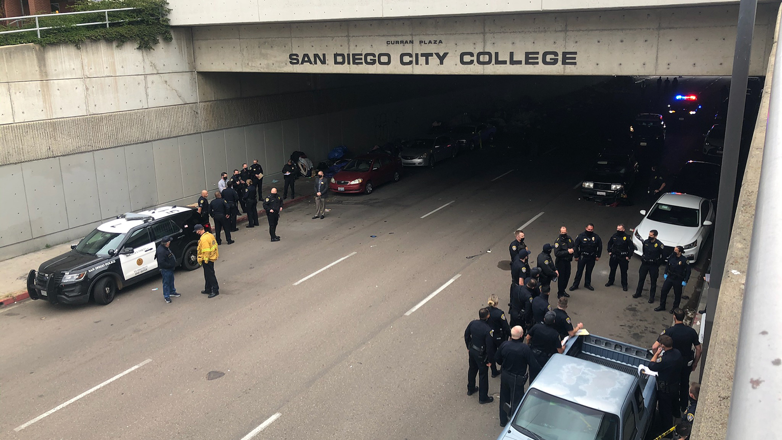 Police gather outside the tunnel along B Street at San Diego City College after a car plowed into at least eight people on the sidewalk on Monday, March 15, 2021.