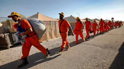 Inmates with the California Department of Corrections and Rehabilitation work on a fire crew during the Thomas Fire in Ventura, CA, on Dec. 12, 2017.