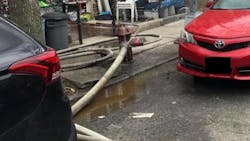 Two vehicles are parked too close to a fire hydrant while FDNY crews operate at a residential fire in Brooklyn on Feb. 28, 2021.