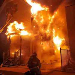 West Springfield, MA, crews battled a three-alarm fire Sunday, and two trapped residents used a plank to reach an adjacent roof so that firefighters could rescue them.
