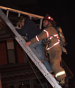 Guiding civilians down a ladder after they were rescued from a window provides them with a measure of safety. Guiding civilians down a ladder after they were rescued from a window provides them with a measure of safety.