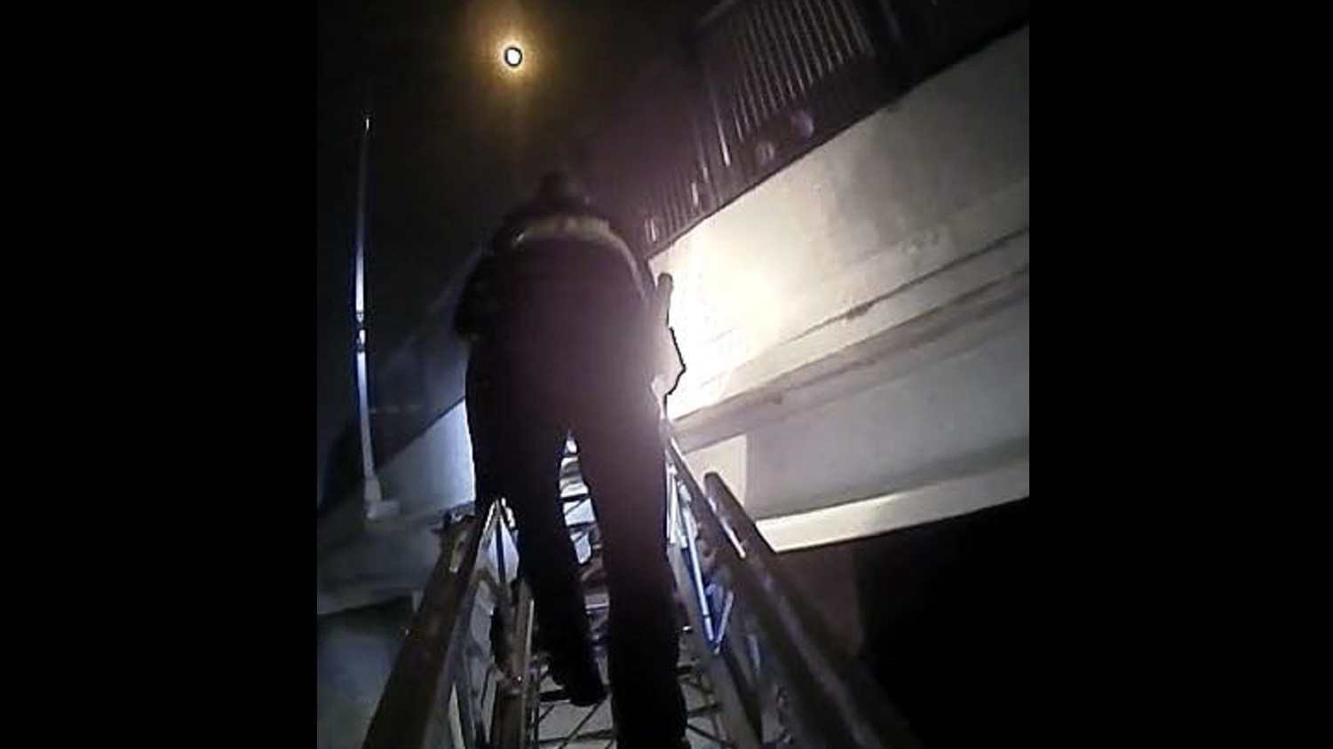 Ames, IA, firefighters and police officers rescued 'a distraught adult female grasping the railing' of a bridge over railroad tracks early Thursday.