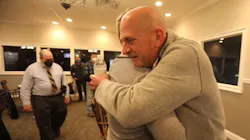 Retired Arlington, NY, firefighter William Porter embraces Jacob Tsukroff, who Porter had saved from a fatal fire in 1998, during a reunion in Poughkeepsie on Sunday.