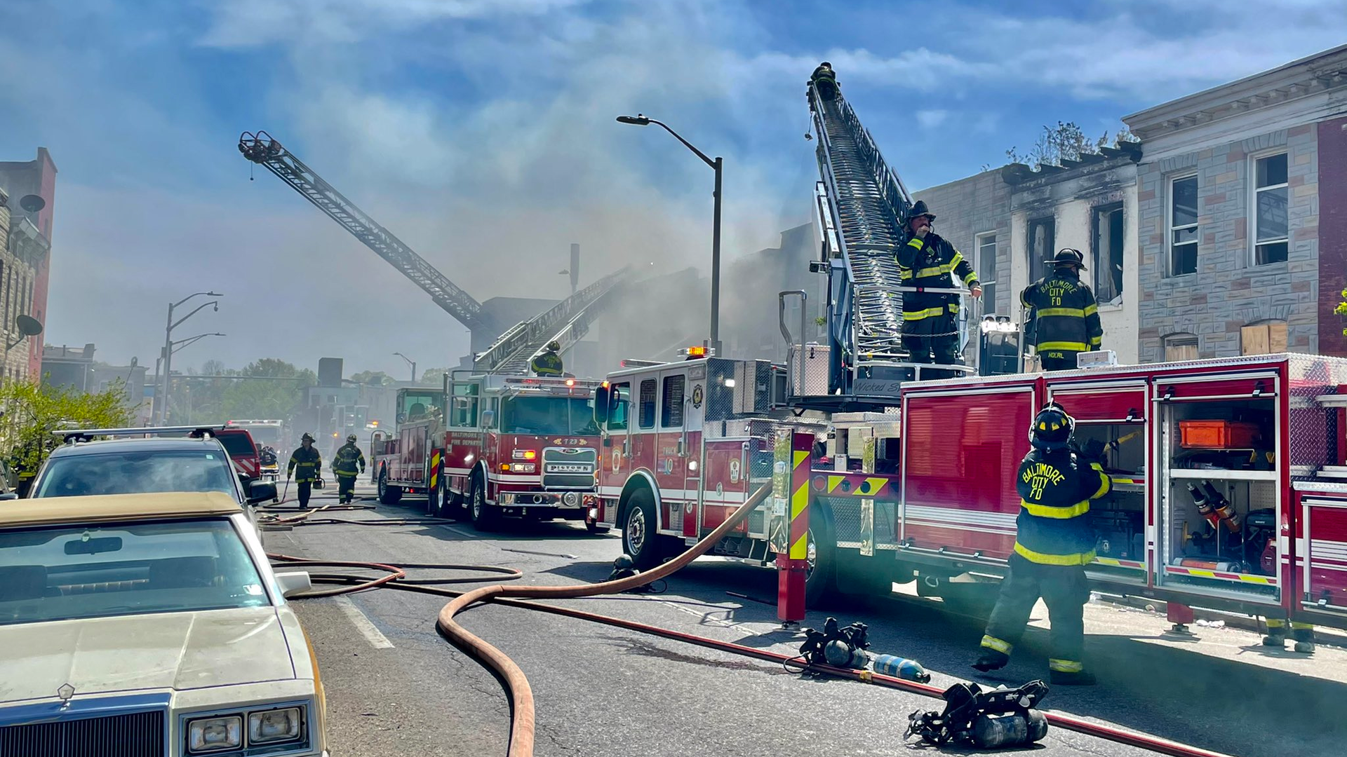 Baltimore City firefighters battled a five-alarm blaze that spread to homes on multiple streets Friday.
