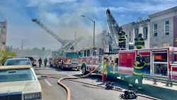 Baltimore City firefighters battled a five-alarm blaze that spread to homes on multiple streets Friday.