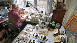 Bob Stella of Weymouth, MA, found a niche business in painting the colorful leather shields firefighters put on their helmets.