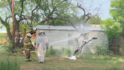 A Breckenridge, TX, firefighter and a beekeeper use foam to deal with a 'very aggressive' bee swarm at a home Monday. A Breckenridge, TX, firefighter and a beekeeper use foam to deal with a 'very aggressive' bee swarm at a home Monday.