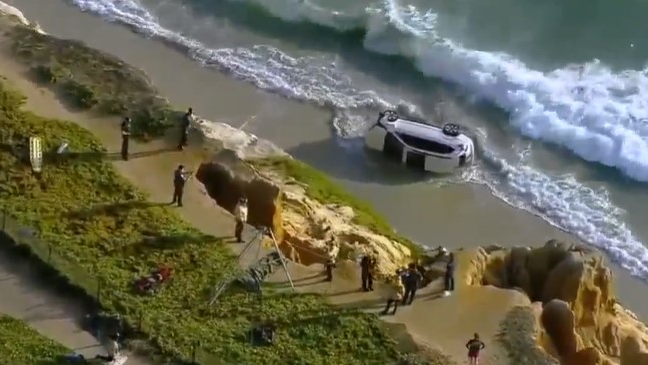 Carlsbad, CA, firefighters helped rescue a driver whose car plunged off a cliff and into the ocean Tuesday.