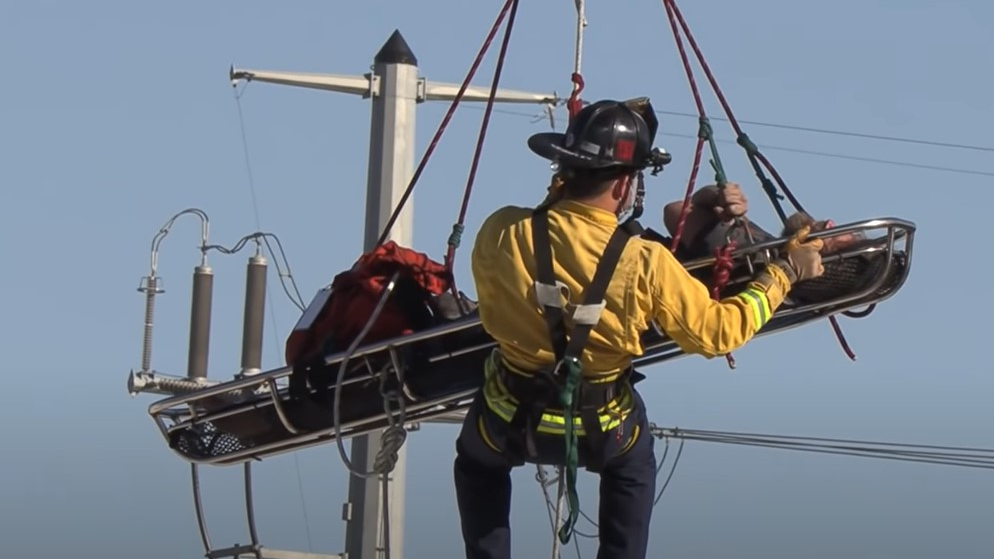 A Chula Vista, CA, firefighter rescues a suspected burglar who fell through an empty warehouse skylight and became entangled in copper wires Monday.