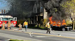 Sadsbury, PA, firefighters extinguish a burning car that rolled down a hill Tuesday.