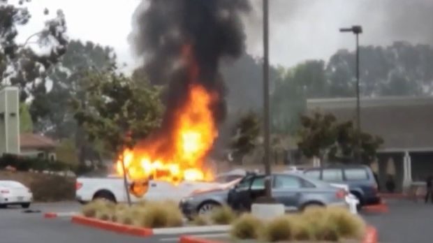 Flames from a burning car in a Del Mar, CA, parking lot spread to another vehicle and ignited ammunition inside Tuesday.