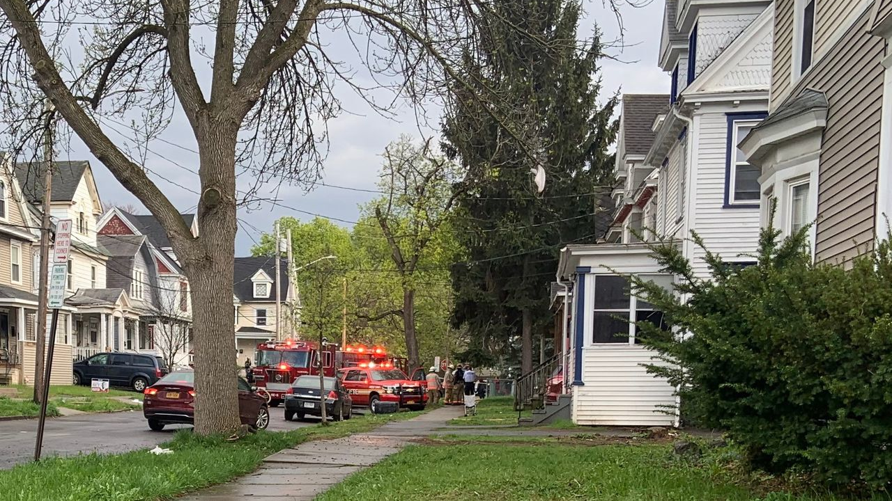 Syracuse, NY, firefighters rescued an unconscious woman from a burning house Wednesday.