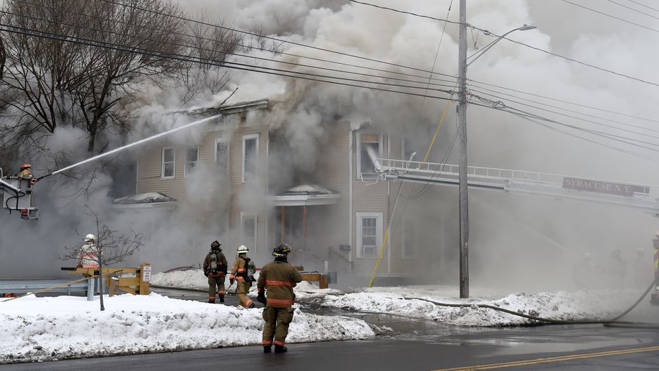 Syracuse, NY, firefighters battle a house fire on Feb. 19.
